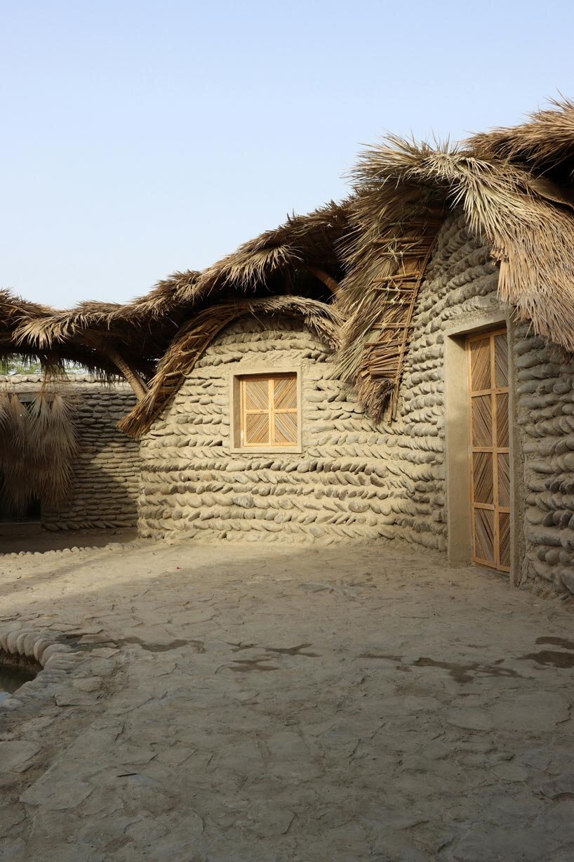 vaulted palm canopy shields dry stone guesthouse cluster in southeastern iran