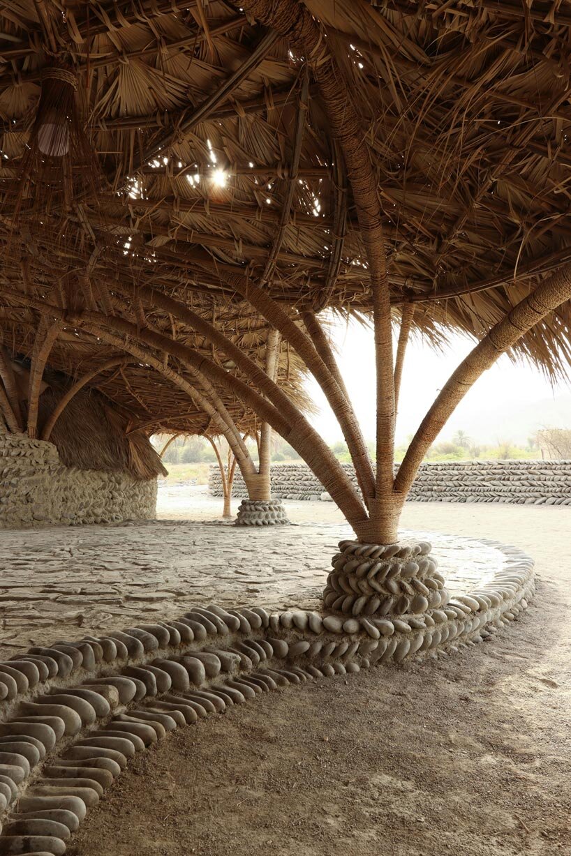 vaulted palm canopy shields dry stone guesthouse cluster in southeastern iran