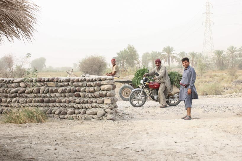 vaulted palm canopy shields dry stone guesthouse cluster in southeastern iran