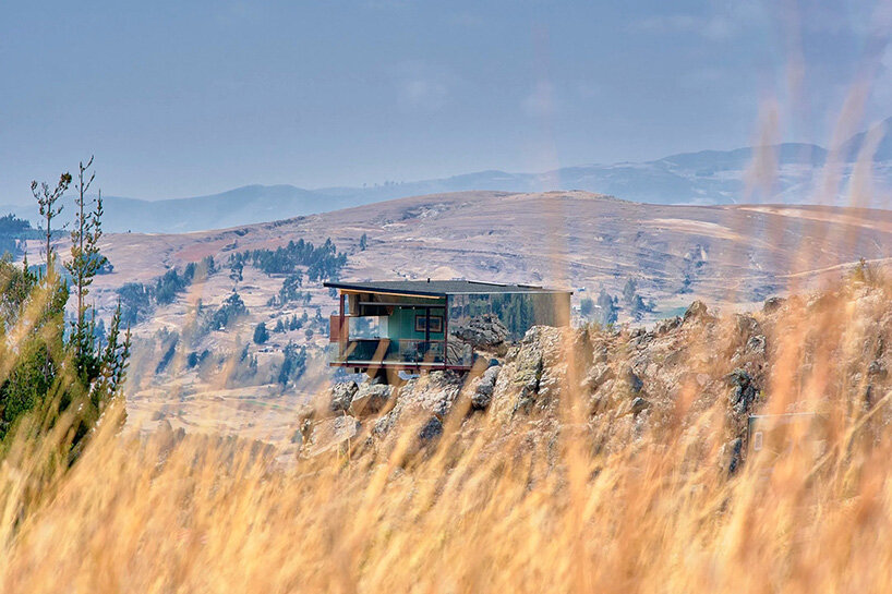reflective glass surfaces mirror the rocky terrain across andean cabin by rtresarquitectos