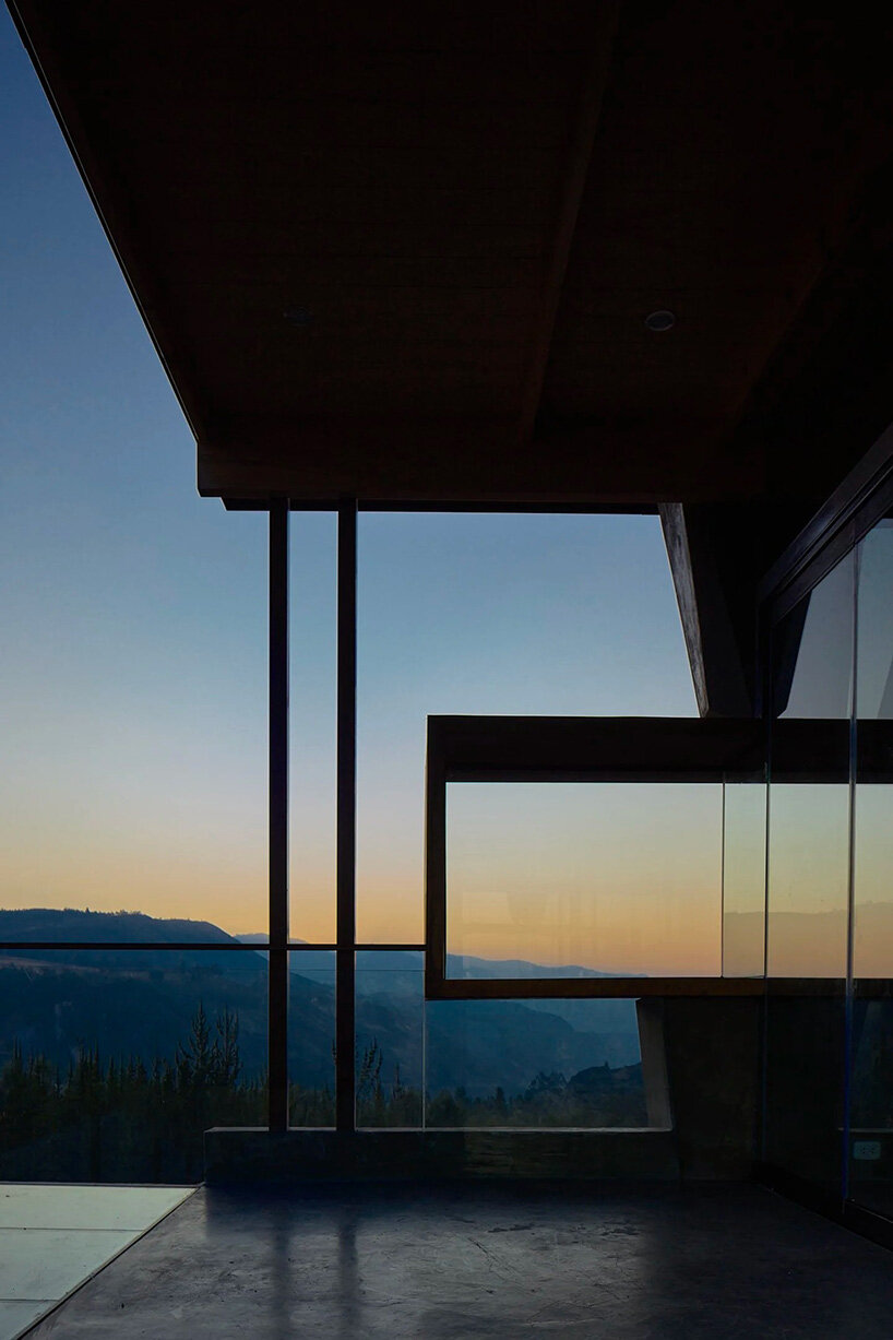 reflective glass surfaces mirror the rocky terrain across andean cabin by rtresarquitectos