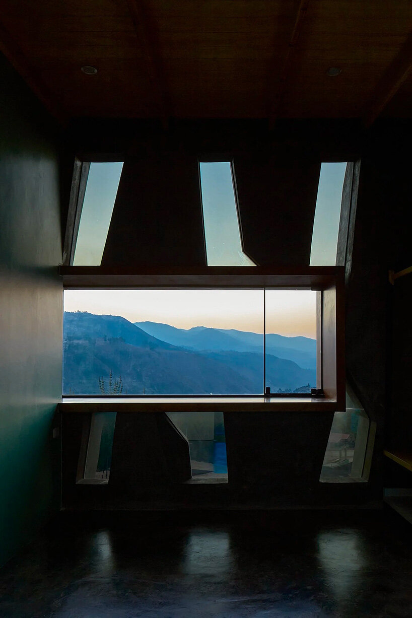 reflective glass surfaces mirror the rocky terrain across andean cabin by rtresarquitectos