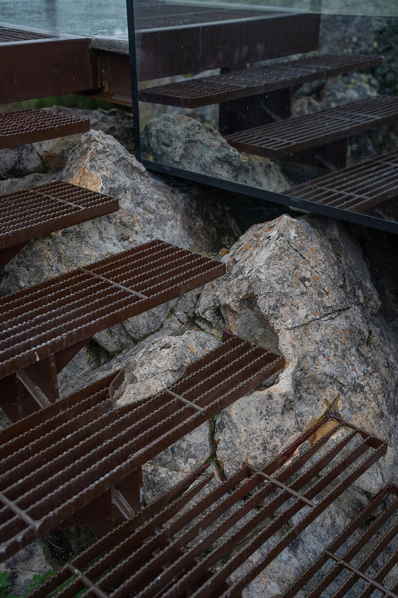 reflective glass surfaces mirror the rocky terrain across andean cabin by rtresarquitectos