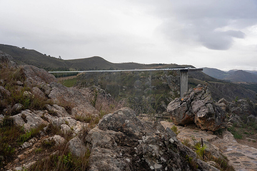 reflective glass surfaces mirror the rocky terrain across andean cabin by rtresarquitectos