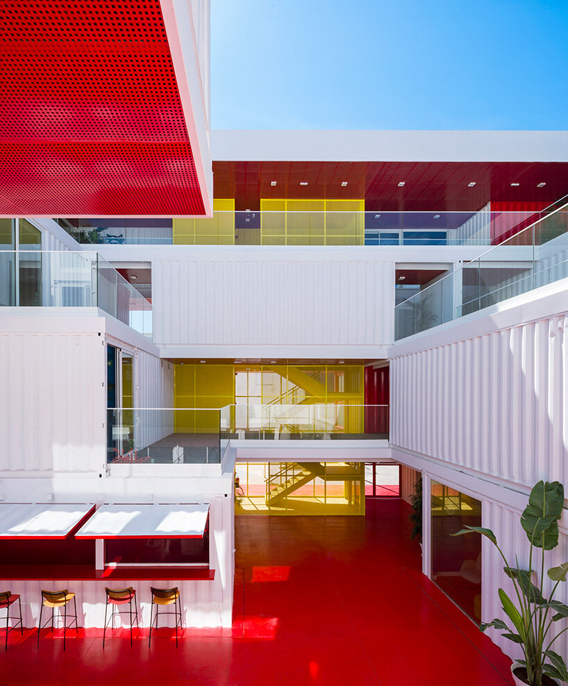 reused shipping containers form high-tech incubator by carquero arquitectura in spain