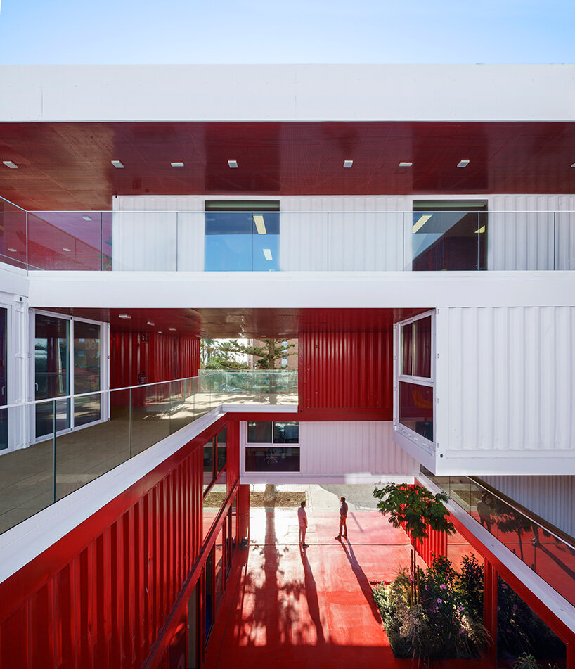 reused shipping containers form high-tech incubator by carquero arquitectura in spain