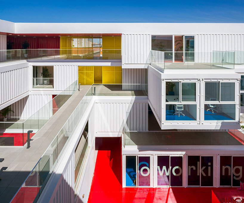 reused shipping containers form high-tech incubator by carquero arquitectura in spain