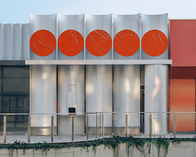 row of circular red panels lines the facade of café on-site by aptdotapt in china