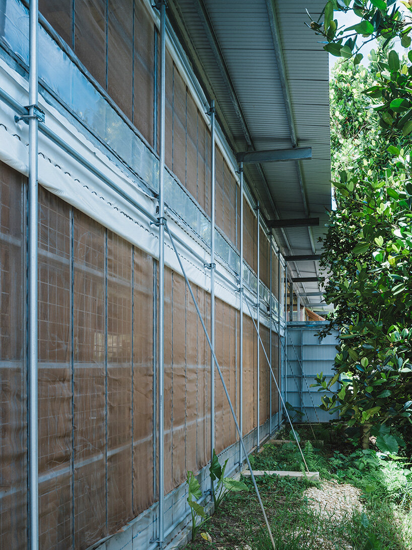 studio cochi architects wraps okinawa workspace in double-skin of insect netting and vinyl