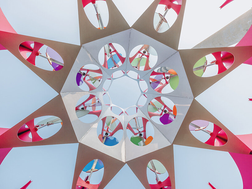 suspended colored discs move through daxing jizi design's faceted installation in beijing