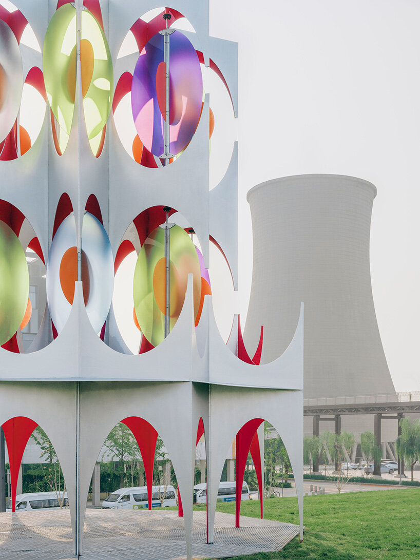 suspended colored discs move through daxing jizi design's faceted installation in beijing