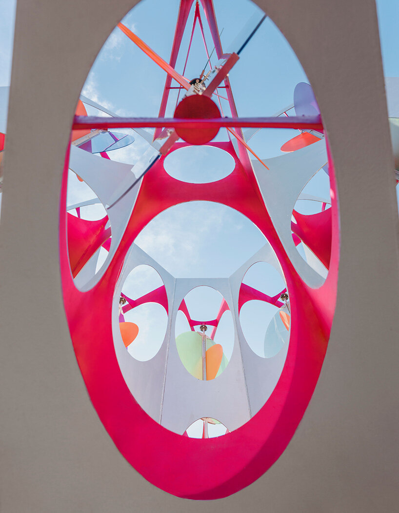 suspended colored discs move through daxing jizi design's faceted installation in beijing