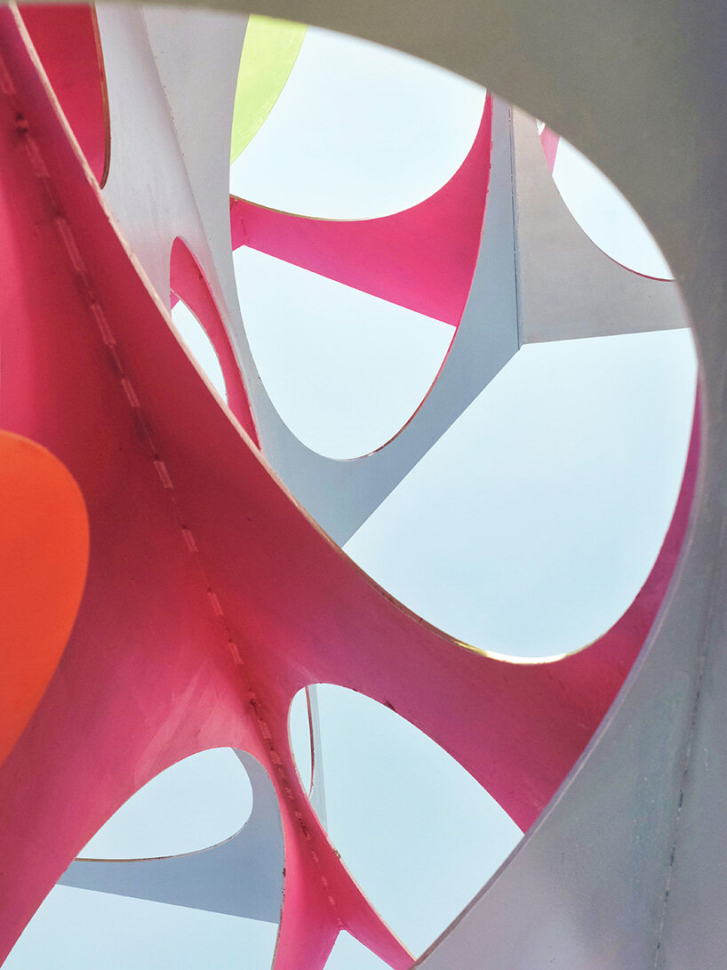 suspended colored discs move through daxing jizi design's faceted installation in beijing