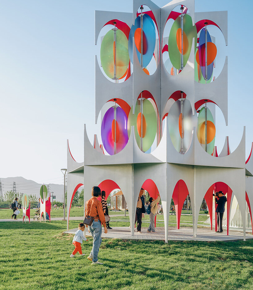 suspended colored discs move through daxing jizi design's faceted installation in beijing