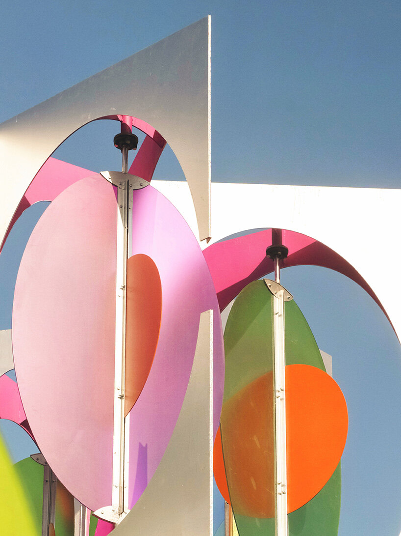 suspended colored discs move through daxing jizi design's faceted installation in beijing