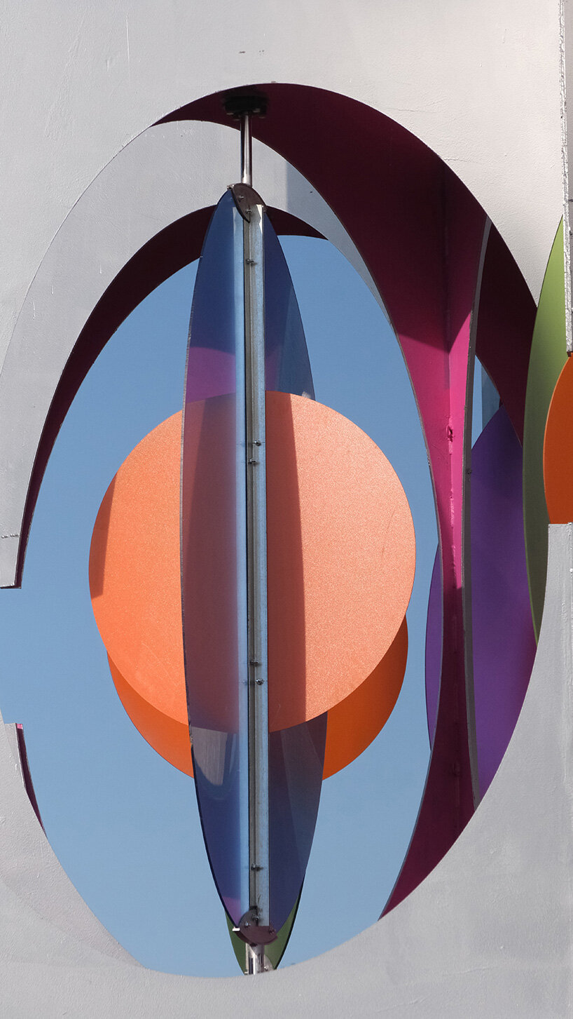 suspended colored discs move through daxing jizi design's faceted installation in beijing