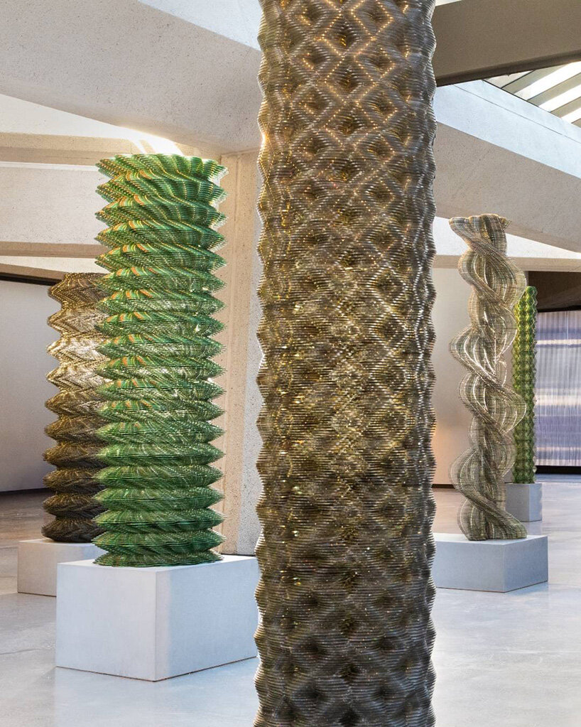 thousands of recycled CDs form reflective vertical sculptures in tara donovan's stratagems