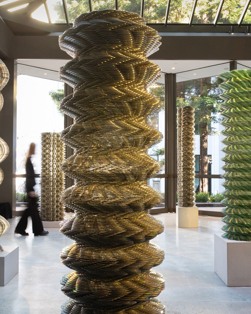 thousands of recycled CDs form reflective vertical sculptures in tara donovan's stratagems