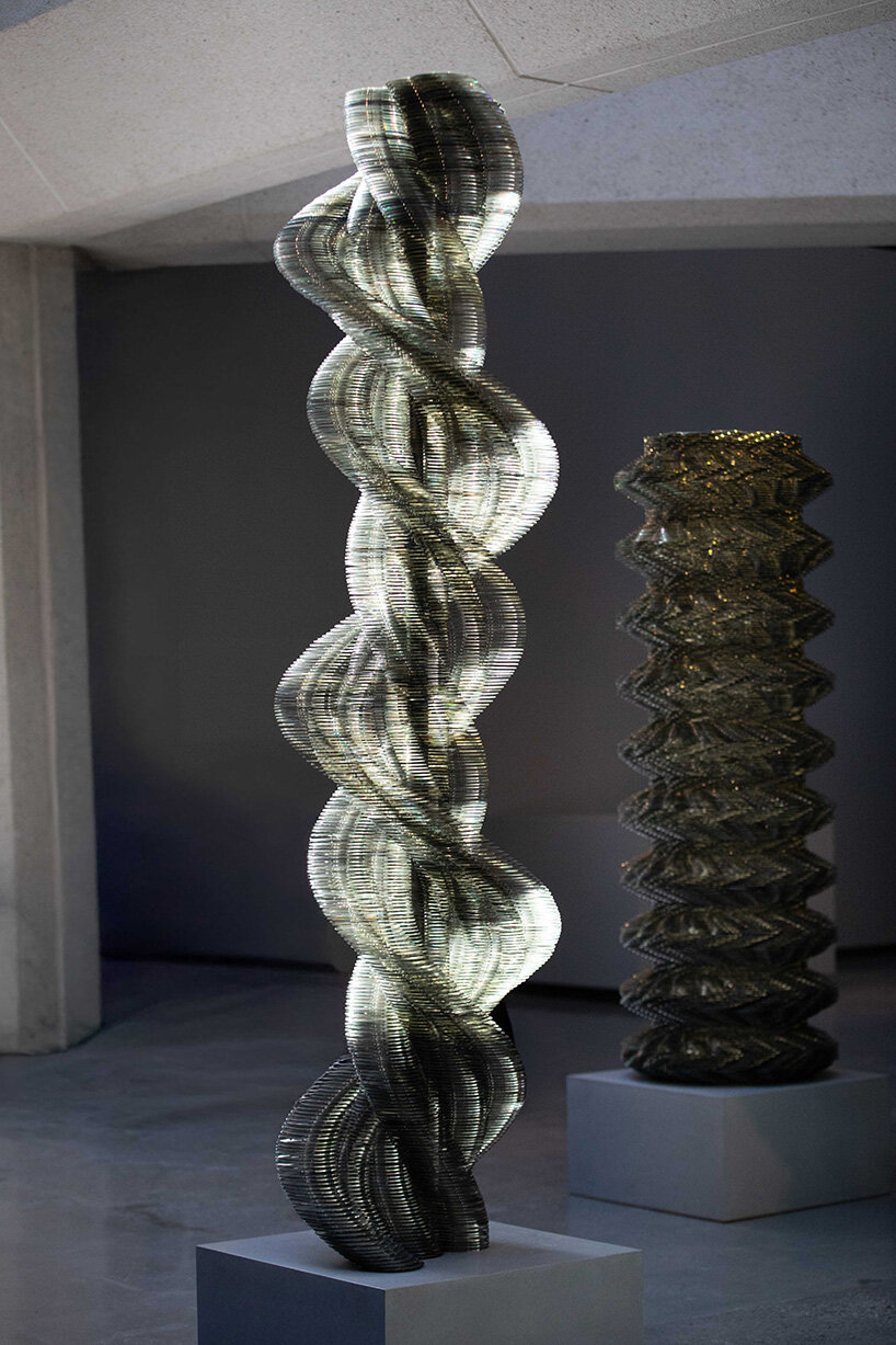 thousands of recycled CDs form reflective vertical sculptures in tara donovan's stratagems