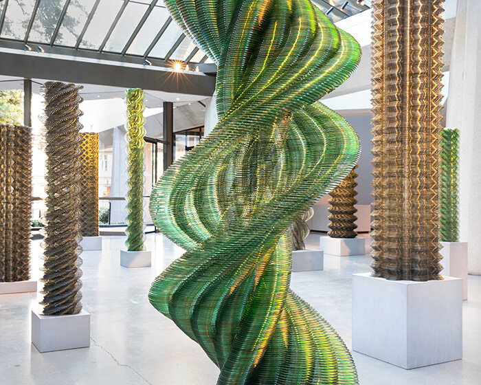 thousands of recycled CDs form reflective vertical sculptures in tara donovan's stratagems