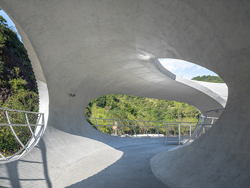 tubular concrete ring by HCCH studio shapes cycling rest pavilion among chinese hills