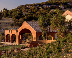 lime-washed facade in terracotta tones enfolds urla family home in turkey
