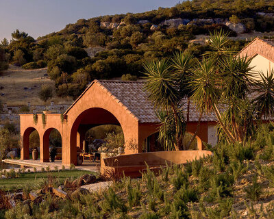 lime-washed facade in terracotta tones enfolds urla family home in turkey