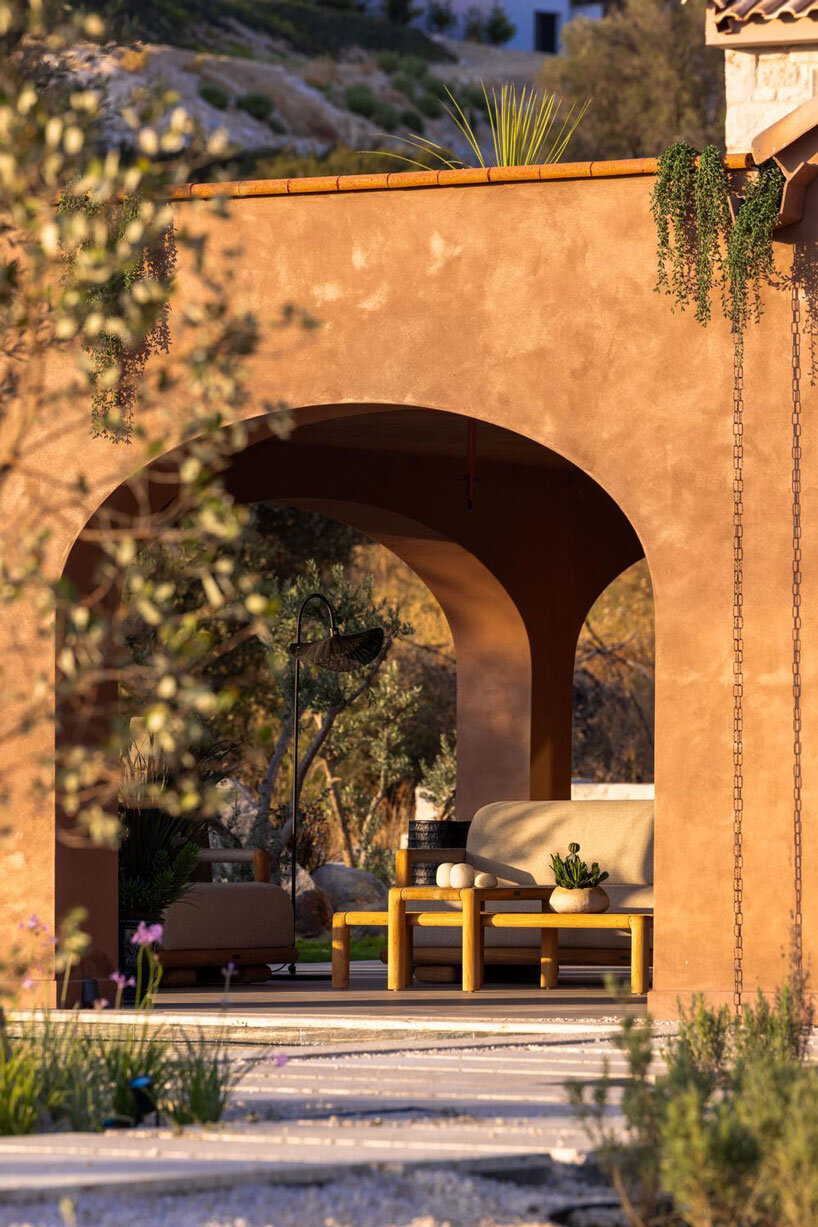 lime-washed facade in terracotta tones enfolds urla family home in turkey