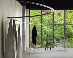 continuous steel rail traces shanghai showroom’s sculptural interior, like a freehand drawing