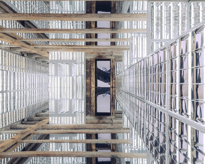 alexandre de betak inserts reflective light installation into traditional swiss barn