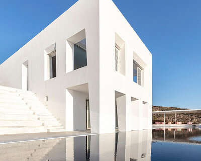 monolithic white 'avlakia house' overlooks rugged island of antiparos, greece