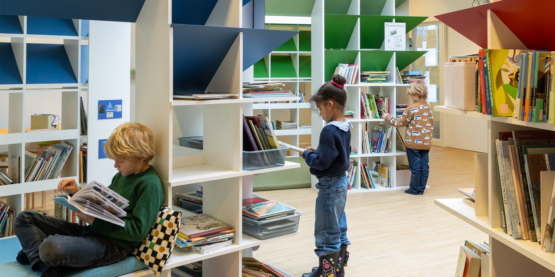 children-reading-village-colorful-huts-transformed-paris-school-library-header