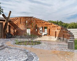 curved brick patterned walls frame farmhouse by manoj patel in india