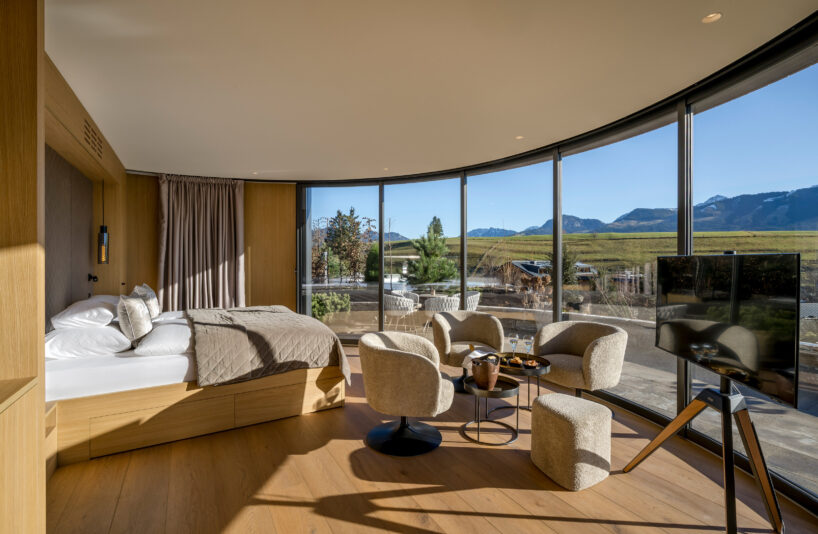 curved cabins show off 180 degree mountain view at sonnenalp resort in southern germany