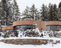 curved cabins show off 180 degree mountain view at sonnenalp resort in southern germany