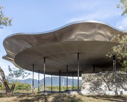 metal lotus roof of tie-ma cycling station floats next to taiwan's dapo pond