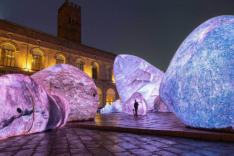 ENESS installs luminous inflatable boulders in bologna's historic piazza maggiore