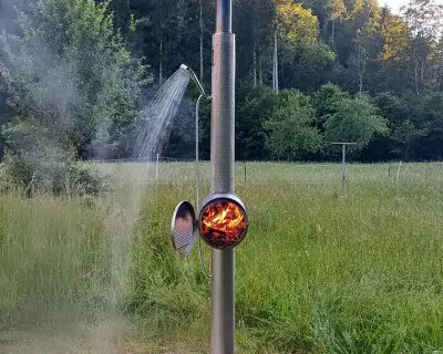 garden shower made of steel uses integrated wood stove to heat up the water