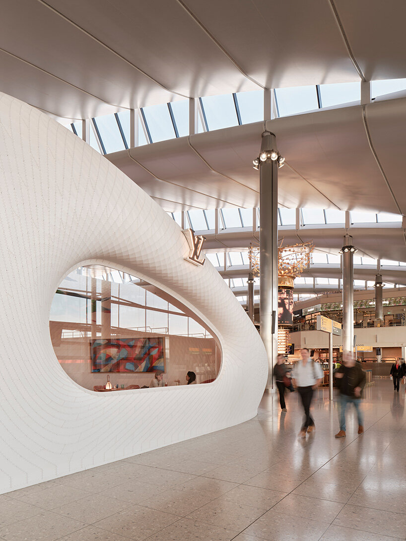 marc fornes / THEVERYMANY lands fuselage-like louis vuitton caf&eacute; and store at heathrow
