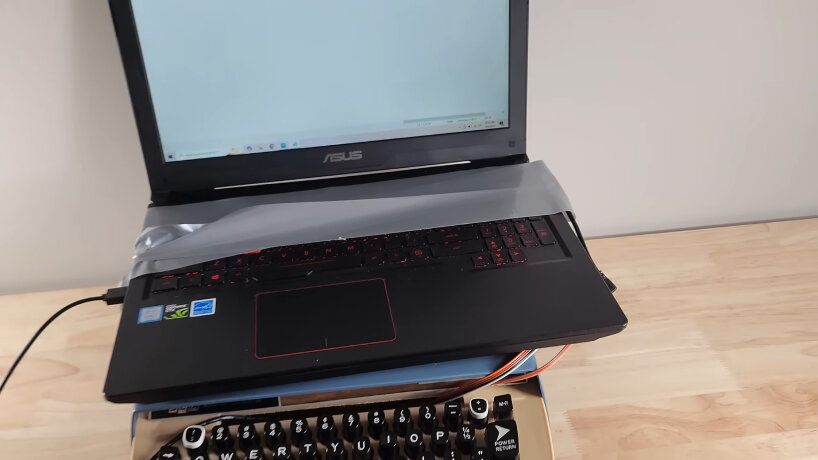 view of the revived laptop attached on top of the custome typewriter