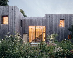 studio bark shapes low carbon 'orchard house' as two silvery larch-clad cubes