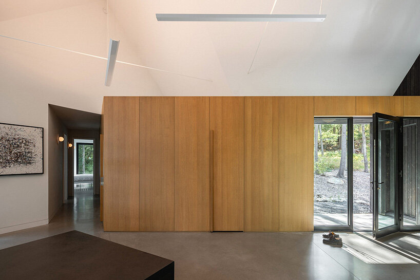 paul bernier architecte fragments residence on quebec's lake brompton into three wings