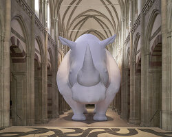 an inflatable rhinoceros occupies the medieval gallery of kunstmuseum magdeburg