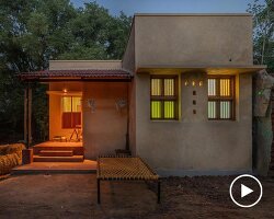 thousands of reclaimed bricks shape rural residence amid agricultural fields in india