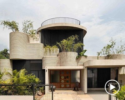 circular green terraces carve through exposed concrete facade in india