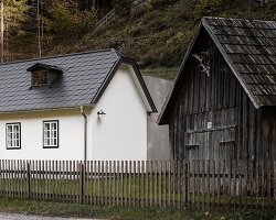 two-centuries old farmhouse and contemporary extension face off in austrian hillscape
