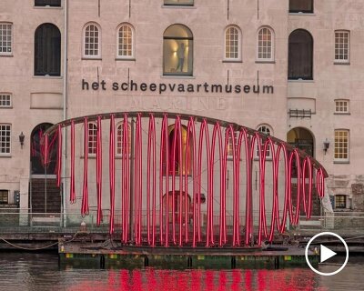 whale skeletal light installation glows red for amsterdam light festival