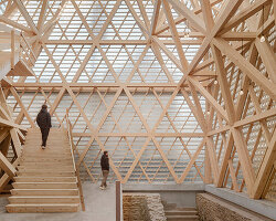 translucent glass shingles wrap timber-framed museum intervention by wulf architekten