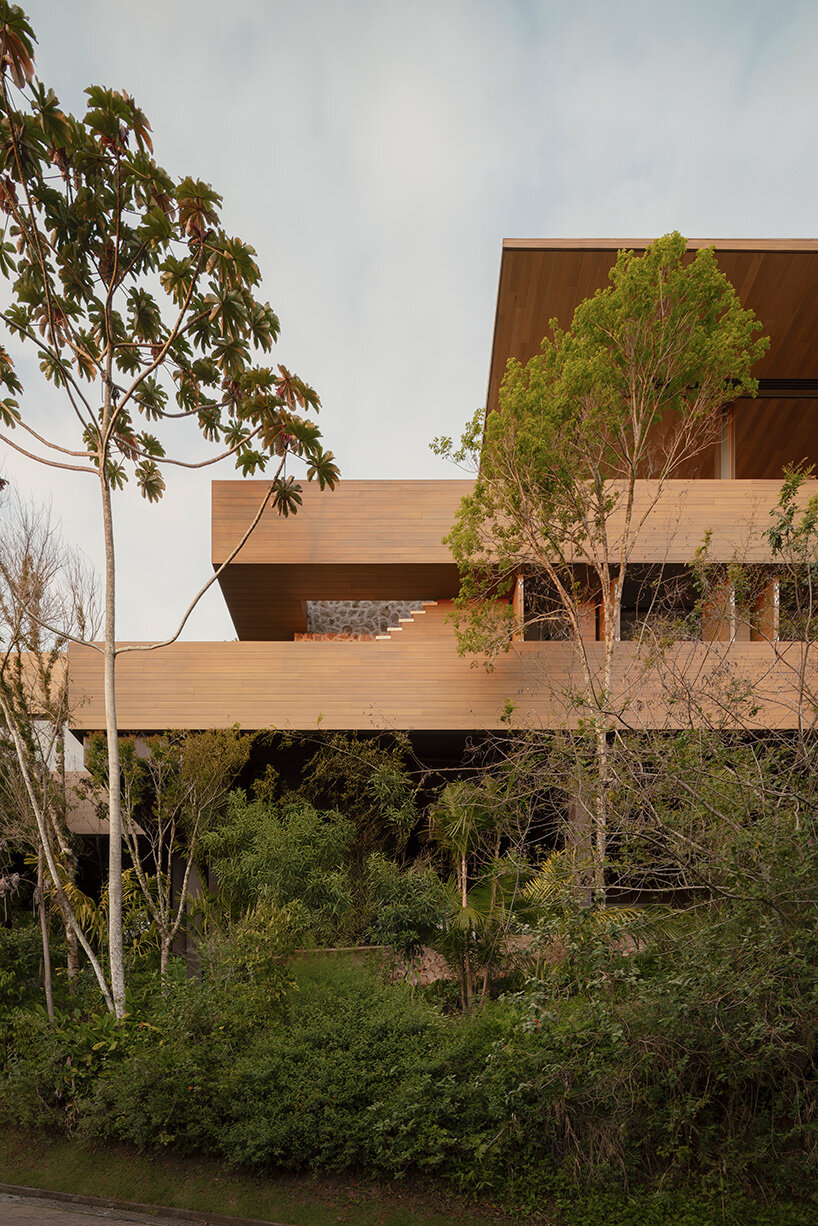 arthur casas adapts speculative structure into wood-lined coastal house in brazil - 5