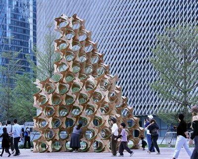 hundreds of interlocking star modules build a porous timber installation